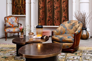 Elegant showroom with armchairs upholstered in Prelle silks and matching curtains